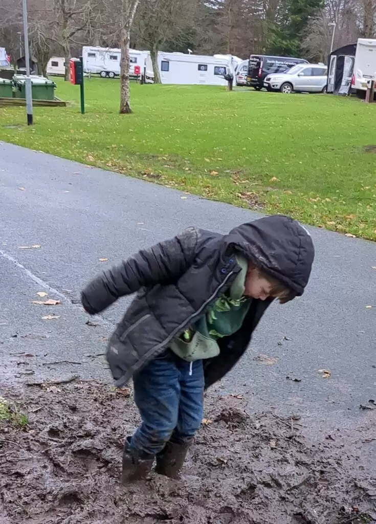 Tollymore Forest parks carvan and camping park, one happy child playing in the mud