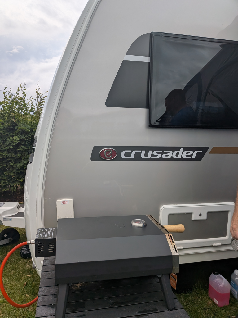 Lidls Gas Pizza oven connected to the BBQ point on the caravan